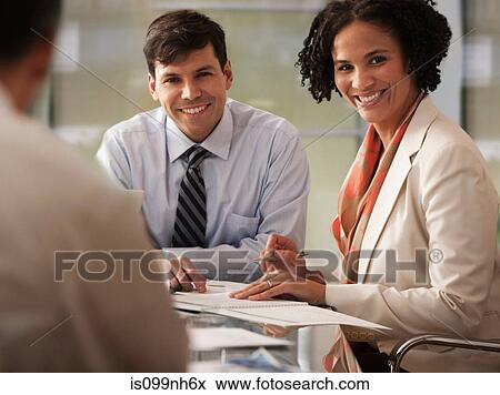Colleagues in business meeting, smiling View Large Photo Image Stock Photo - Colleagues in business meeting, smiling. Fotosearch