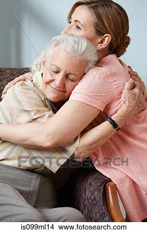 Daughter and senior mother embracing View Large Photo Image Picture - Daughter and senior mother embracing. Fotosearch