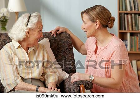 Daughter visiting senior mother in care home View Large Photo Image Stock Photograph - Daughter visiting senior mother in care home. Fotosearch