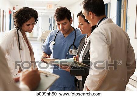 Doctors discussing patients charts in hospital View Large Photo Image Stock Image - Doctors discussing patients charts in hospital. Fotosearch