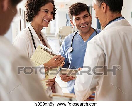 Doctors holding medical records in discussion View Large Photo Image Stock Photo - Doctors holding medical records in discussion. Fotosearch