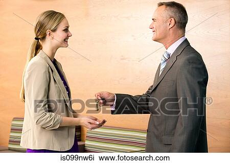 Estate agent giving keys to customer View Large Photo Image Stock Image - Estate agent giving keys to customer. Fotosearch
