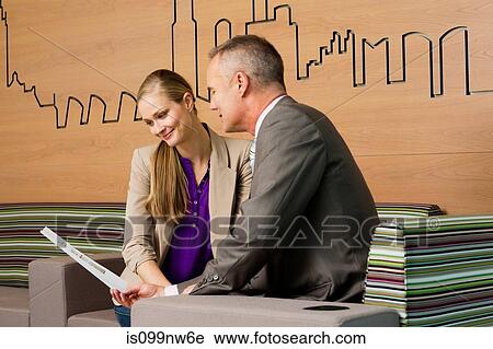 Stock Image - Estate agent meeting with client in office. Fotosearch