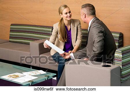 Stock Image - Estate agent meeting with client in office. Fotosearch