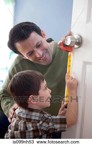 Father and son measuring door at home View Large Photo Image Stock Image - Father and son measuring door at home. Fotosearch