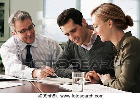Stock Image - Financial advisor meeting with young couple. Fotosearch
