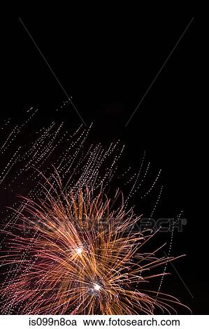 Fireworks exploding against night sky View Large Photo Image Stock Image - Fireworks exploding against night sky. Fotosearch