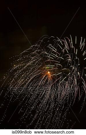 Fireworks exploding against night sky View Large Photo Image Stock Image - Fireworks exploding against night sky. Fotosearch