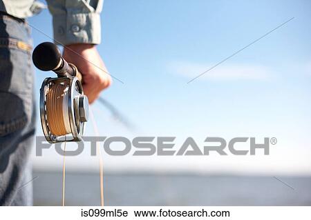 Fisherman holding a fly rod View Large Photo Image Stock Image - Fisherman holding a fly rod. Fotosearch