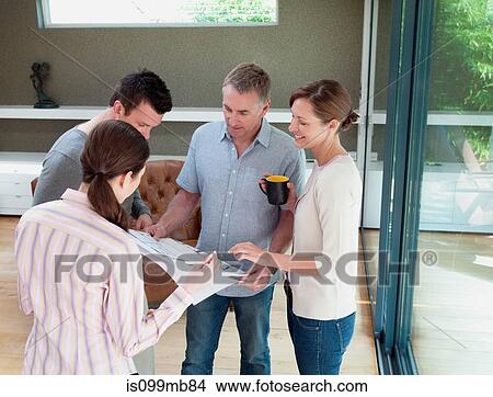 Four people looking at blueprint View Large Photo Image Picture - Four people looking at blueprint. Fotosearch