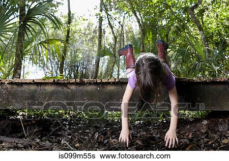 Girl lying on boardwalk View Large Photo Image Stock Photograph - Girl lying on boardwalk. Fotosearch