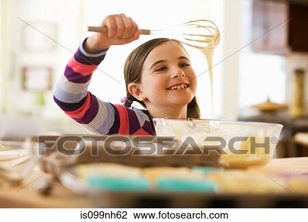 Girl mixing cake batter in bowl View Large Photo Image Stock Image - Girl mixing cake batter in bowl. Fotosearch