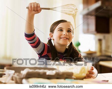 Girl mixing cake batter in bowl View Large Photo Image Stock Photo - Girl mixing cake batter in bowl. Fotosearch