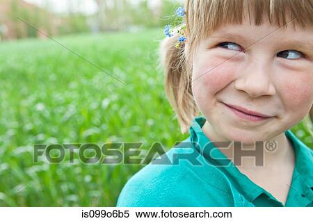 Stock Photography - Girl outdoors with flowers in her hair. Fotosearch