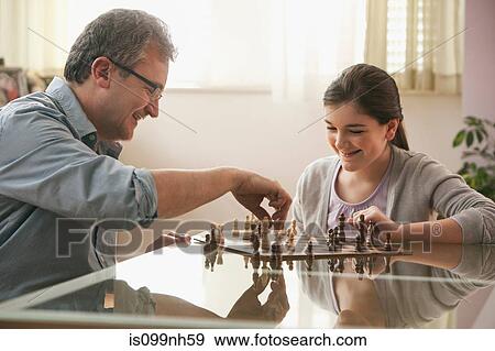 Mature man playing chess with daughter View Large Photo Image Stock Photo - Mature man playing chess with daughter. Fotosearch