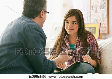 Mature man speaking to daughter about homework View Large Photo Image Stock Photograph - Mature man speaking to daughter about homework. Fotosearch