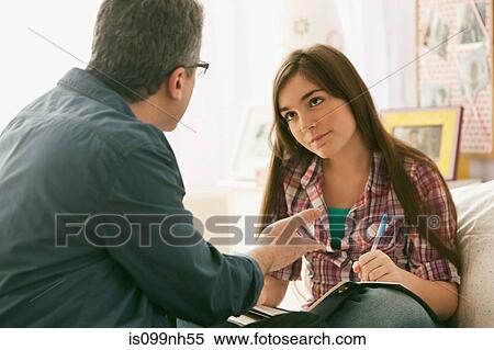 Mature man speaking to daughter about homework View Large Photo Image Stock Photography - Mature man speaking to daughter about homework. Fotosearch