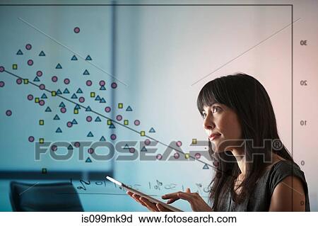 Mature woman using digital tablet with diagram of shapes on window View Large Photo Image Stock Image - Mature woman using digital tablet with diagram of shapes on window. Fotosearch