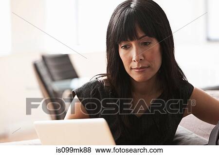 Stock Photo - Mature woman using laptop. Fotosearch