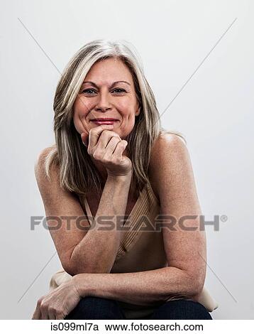 Mature woman with hand on chin View Large Photo Image Stock Image - Mature woman with hand on chin. Fotosearch