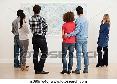 Men and women looking at oil painting in art gallery View Large Photo Image Picture - Men and women looking at oil painting in art gallery. Fotosearch