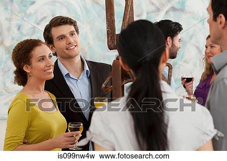 Men and women looking at sculpture in art gallery View Large Photo Image Stock Photo - Men and women looking at sculpture in art gallery. Fotosearch