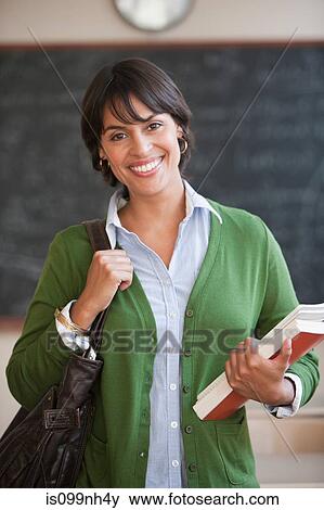 Mid adult woman in classroom, portrait View Large Photo Image Stock Photo - Mid adult woman in classroom, portrait. Fotosearch
