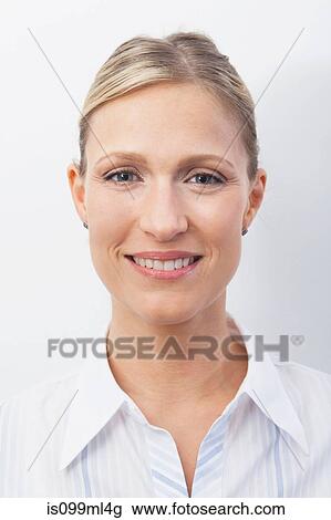 Stock Image - Mid adult woman smiling, portrait. Fotosearch