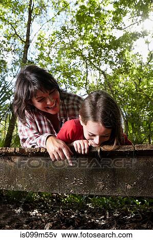 Mother and daughter lying on boardwalk View Large Photo Image Stock Photo - Mother and daughter lying on boardwalk. Fotosearch
