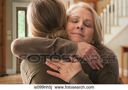 Mother embracing adult daughter View Large Photo Image Stock Image - Mother embracing adult daughter. Fotosearch