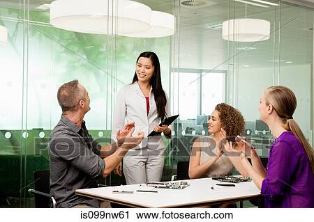 Office colleagues discussing new technologies on desk View Large Photo Image Stock Image - Office colleagues discussing new technologies on desk. Fotosearch