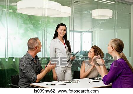 Office colleagues discussing new technologies on desk View Large Photo Image Stock Image - Office colleagues discussing new technologies on desk. Fotosearch