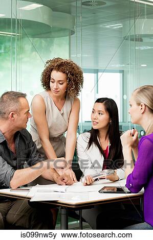 Office colleagues discussing new technologies on desk View Large Photo Image Stock Photo - Office colleagues discussing new technologies on desk. Fotosearch