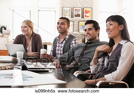 Stock Photograph - Office colleagues in meeting. Fotosearch