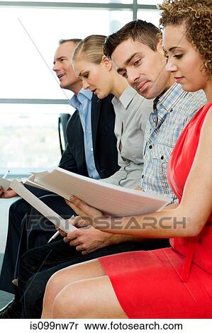 Office colleagues reading documents in office View Large Photo Image Stock Photography - Office colleagues reading documents in office. Fotosearch