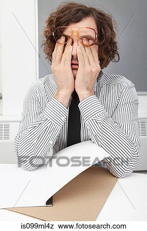 Stock Photo - Office worker rubbing eyes. Fotosearch