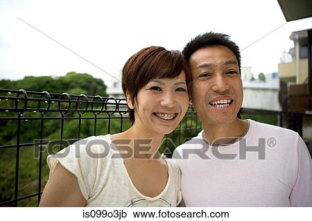 Stock Image - Portrait of a happy couple outdoors. Fotosearch