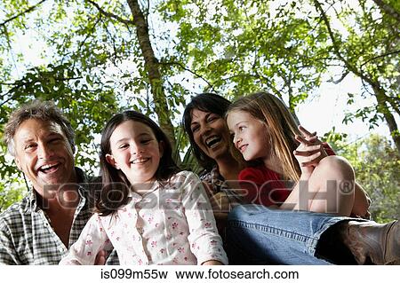 Stock Photo - Portrait of family with two children in forest. Fotosearch