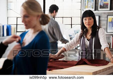 Portrait of fashion designer in busy studio View Large Photo Image Stock Photography - Portrait of fashion designer in busy studio. Fotosearch