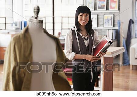 Picture - Portrait of fashion designer in studio. Fotosearch