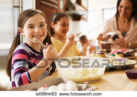 Portrait of girl making cakes with family in kitchen View Large Photo Image Stock Image - Portrait of girl making cakes with family in kitchen. Fotosearch