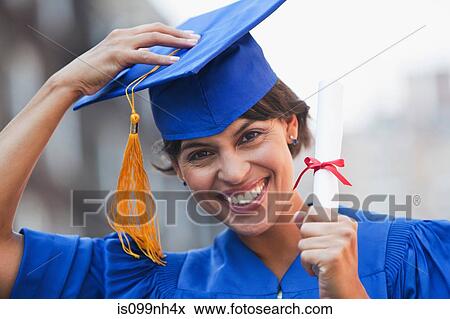 Stock Photo - Portrait of mid adult woman graduating, smiling. Fotosearch