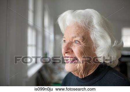 Portrait of senior woman looking out of window View Large Photo Image Stock Photograph - Portrait of senior woman looking out of window. Fotosearch