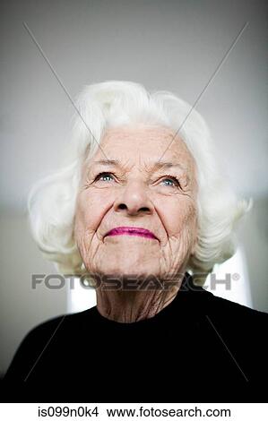 Portrait of senior woman looking up, studio shot View Large Photo Image Picture - Portrait of senior woman looking up, studio shot. Fotosearch
