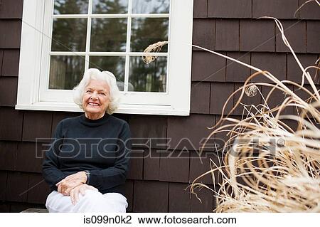Portrait of senior woman outside house View Large Photo Image Stock Image - Portrait of senior woman outside house. Fotosearch