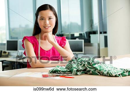 Portrait of young fashion designer at desk View Large Photo Image Stock Image - Portrait of young fashion designer at desk. Fotosearch