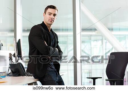 Portrait of young man in IT office View Large Photo Image Picture - Portrait of young man in IT office. Fotosearch