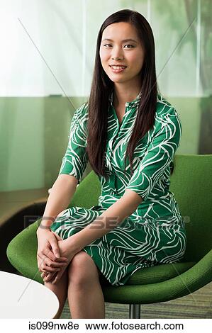 Portrait of young woman in green dress in office View Large Photo Image Stock Image - Portrait of young woman in green dress in office. Fotosearch