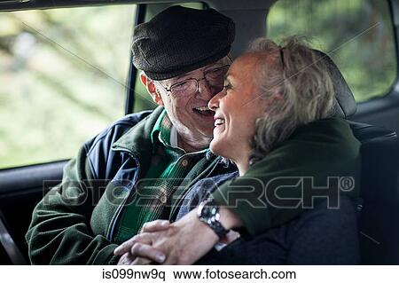 Senior couple embracing in the back of car View Large Photo Image Stock Photography - Senior couple embracing in the back of car. Fotosearch