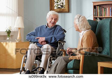 Senior couple in care home, man in wheelchair View Large Photo Image Stock Photo - Senior couple in care home, man in wheelchair. Fotosearch